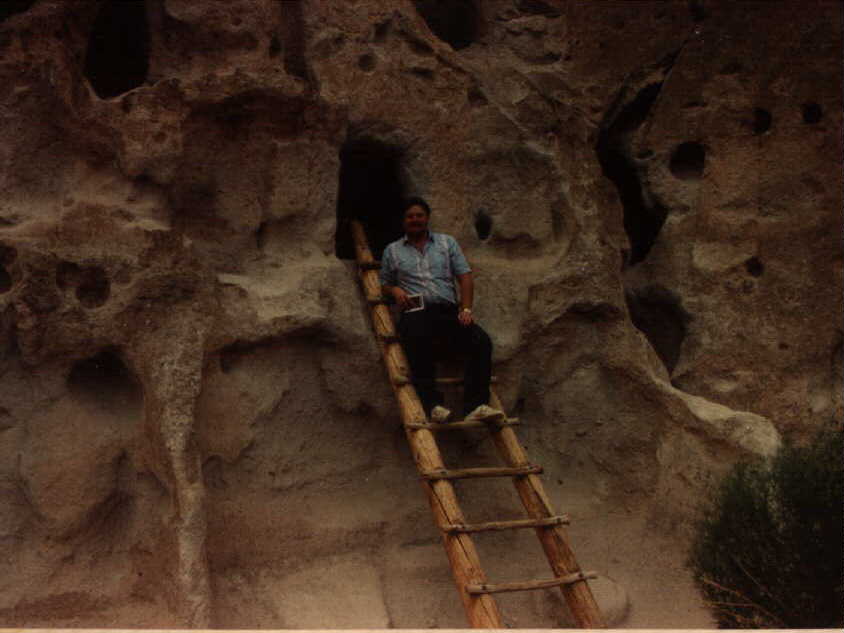 Steve on the ladder of a cliff house in Bandelier National Monument